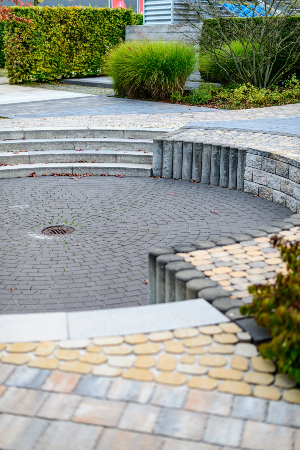 A paved circular seating area with curved steps