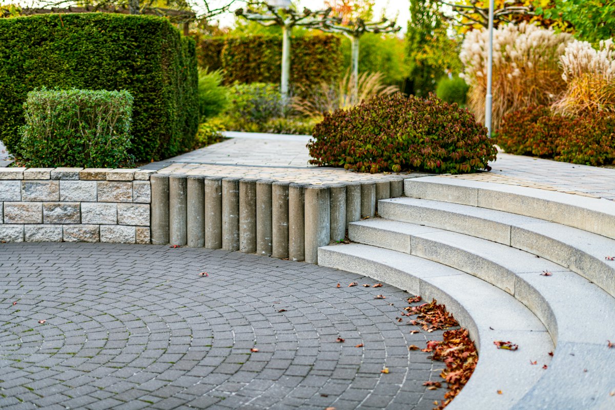 Curved stone steps and seating in a landscaped garden